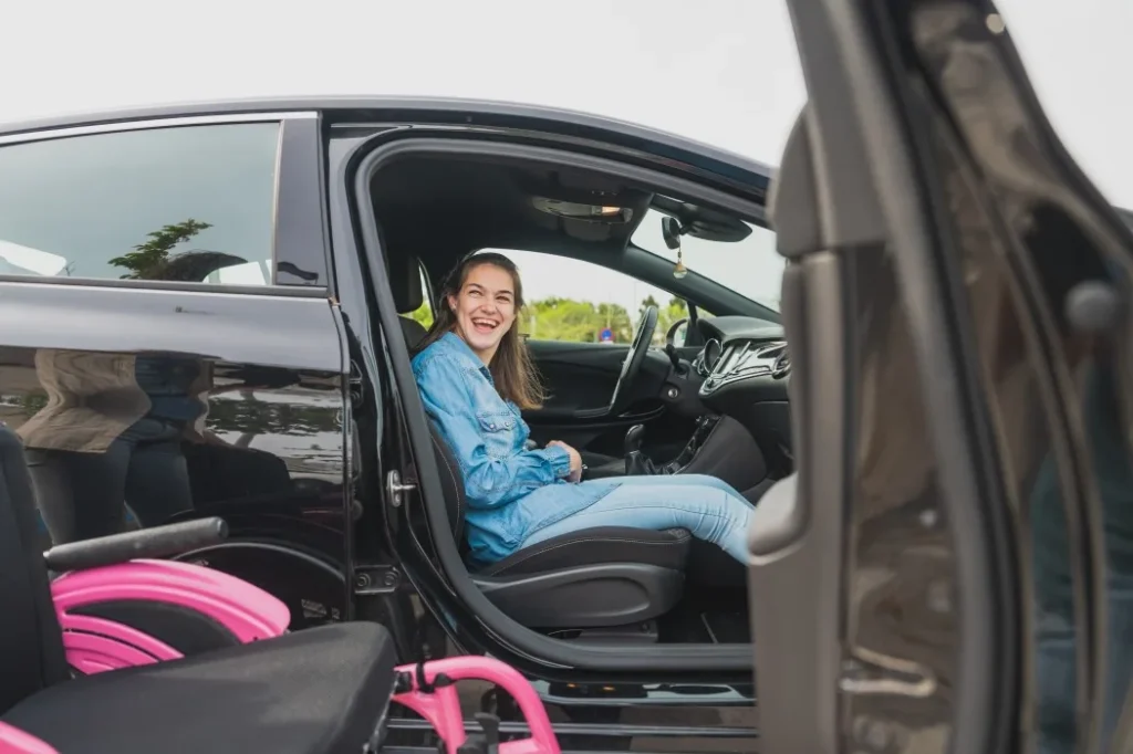 Disabled woman laughing happily in car